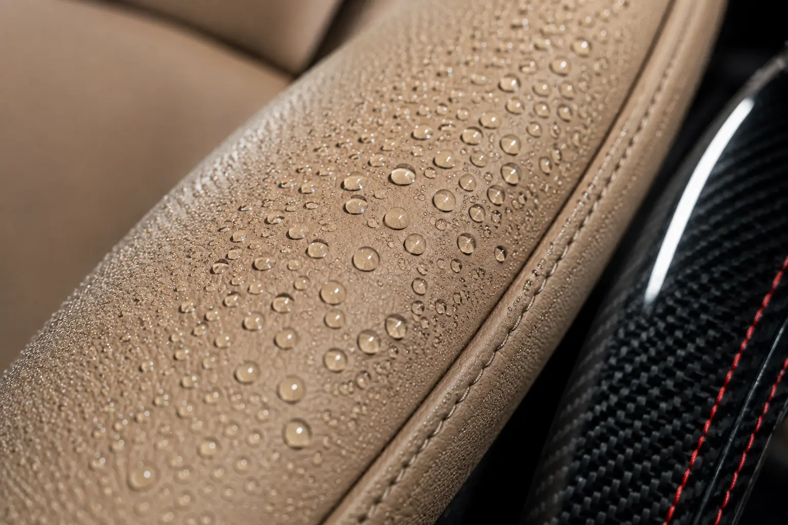 Water beading on a ceramic-coated leather seat bolster inside a supercar