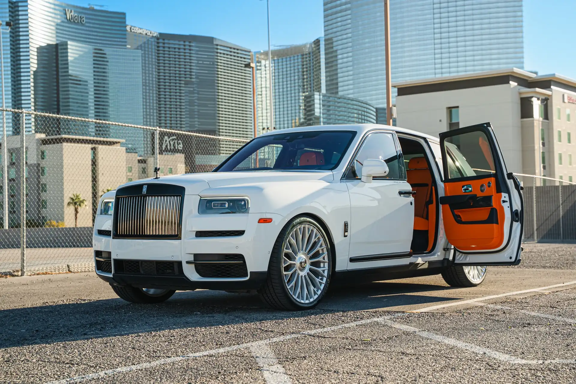 A white Rolls-Royce Cullinan with its doors open in Las Vegas